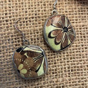 Handmade earrings crafted from small stones with green flowers